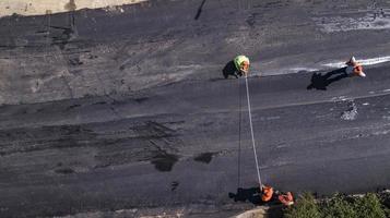 Aerial view on the new asphalt road under construction photo