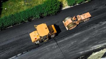 Aerial view on the new asphalt road under construction photo