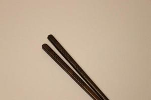 Japanese chopstick illustrated on a plank background with carvings into it photo