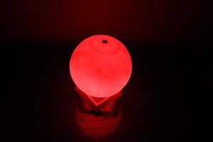 Complex moon lamp that has different colors concepts.This lamp also has a brown support that makes it stand still photo