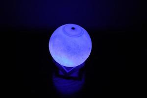 Complex moon lamp that has different colors concepts.This lamp also has a brown support that makes it stand still photo