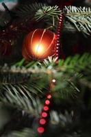 Orange glitter Christmas ball found in a natural tree photo