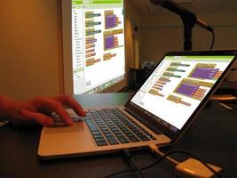 Coding training with the screen that the teacher who teaches coding reflects on the wall with a projection device.Writing Codes Sitting at Desk. Programmer Writing Data Code. photo