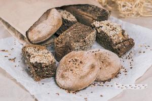 Homemade bread with seeds in a bag and on the table photo