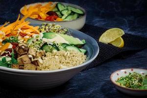 Vegan salad bowls with a variety of colorful vegetables and dressing photo