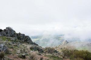 Landscape seen from a hilltop in a foggy day photo