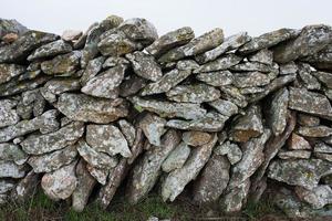 Traditional stone fence in the countryside. photo