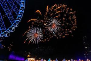 fireworks on the river in the dark sky photo