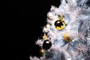 Shiny gold and silver christmas spheres on christmas tree with space for text photo