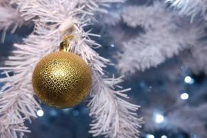 Shiny gold and silver christmas spheres on christmas tree with space for text photo