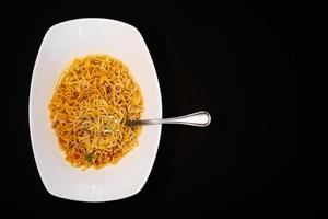 Instant like maruchan soup in white plate on black background photo