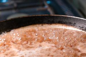 Boiling mexican beans in saucepan photo