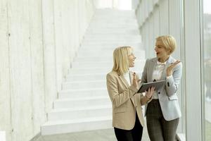 Business women walking in the office corridor photo