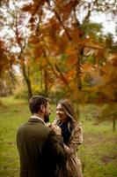 Young couple in the autumn park photo