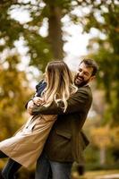 Young couple having fun in the autumn park photo