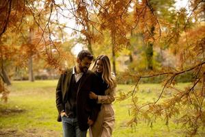 Young couple in the autumn park photo