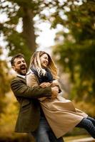 Young couple having fun in the autumn park photo