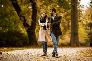 Young couple walking in the autumn park photo