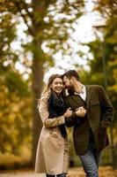 Young couple walking in the autumn park photo