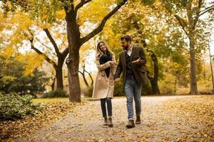 Young couple walking in the autumn park photo