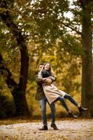 Young couple having fun in the autumn park photo