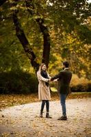 Young couple having fun in the autumn park photo