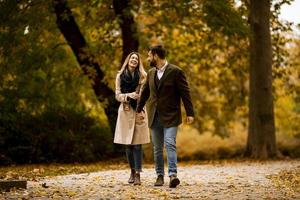 Young couple walking in the autumn park photo