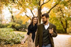 Young couple walking in the autumn park photo