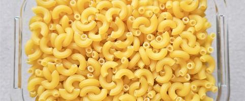 Uncooked elbow macaroni pasta background photo