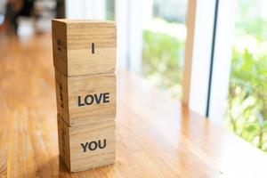 Message I love you spelled in wooden blocks with copy space. i love you word written on wood block. i love you text on table, concept. photo