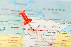 Red clerical needle on a map of USA, Minnesota and the capital Saint Paul. Close up map of Minnesota with red tack photo