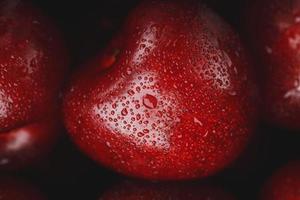 Ripe and fresh berries of a sweet cherry with water drops closeup. photo