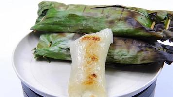 local thai food Sticky rice in coconut milk, seasoned, stuffed with young coconut, wrapped in banana leaves and then grilled to give a pleasant aroma. video