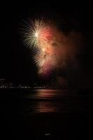 Abstract colored firework background light up the sky with dazzling display photo