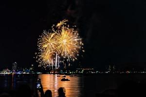 Abstract colored firework background light up the sky with dazzling display photo