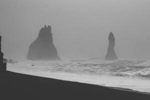 High rocks on beach monochrome landscape photo