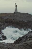 Beacon with tower on rock landscape photo