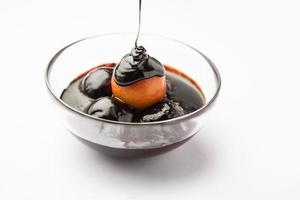 Chocolate dipped gulab jamun, indian creative fusion dessert food photo