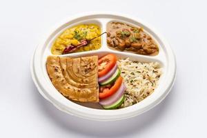 Indian mini meal parcel platter, combo thali with Rajma Masala, roti, dal tadka, jeera rice, salad photo