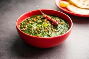 lasooni palak recipe or dhaba style garlic spinach curry, Indian main course served with naan photo