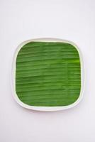 banana leaf on blank plate for edit food or subject on photo