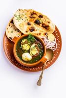 Spinach egg curry is an Indian non vegetarian dish made using palak gravy with eggs photo