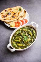 palak baby corn sabzi also known as spinach makai curry served with rice or roti, Indian food photo