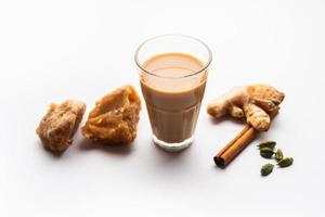 Jaggery tea or Gur ki chai with ingredients like gud, ginger or adrak, green cardamom and cinnamon photo