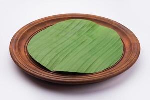 banana leaf on blank plate for edit food or subject on photo