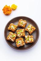 Dodha Barfi or Doda Burfi is a traditional Indian sweet, which has a grainy and chewy texture photo