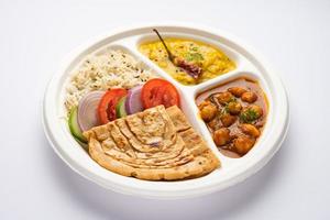 Indian mini meal parcel platter, combo thali with chole Masala, roti, dal tarka, jeera rice, salad photo