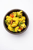 Indian phool Gobi Shimla Mirch Sabji Recipe or Capsicum Cauliflower Sabzi, a healthy and homemade dry vegetable dish. photo