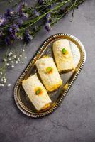 Malai Chop or Cream sandwich made using filling Rasgulla or Gulab jamun sweet is a Bengali sweet photo