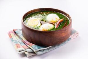 Spinach egg curry is an Indian non vegetarian dish made using palak gravy with eggs photo
